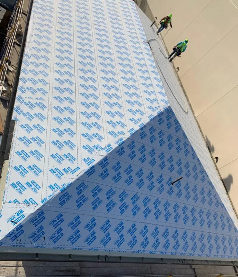 Professional roofers installing underlayment on a metal roof in Camp Pendleton Mainside